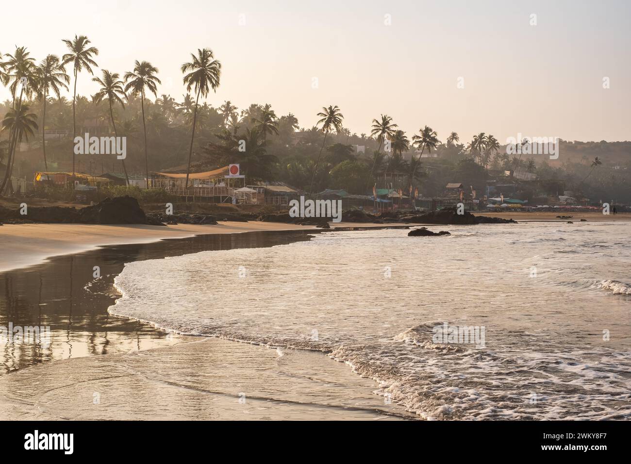 Vagator or Ozran beach aerial panoramic view in north Goa, India. Goa beach early morning before sunrise view of palm trees and restaurants on the bea Stock Photo