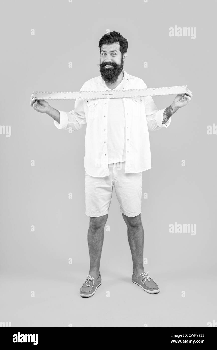 happy man with measuring ruler isolated on yellow. man with measuring ...