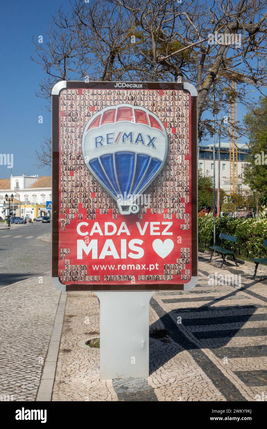 Remax Real Estate Business In Portugal Corporate Advertising Sign Poster In Faro City Centre Portugal, Remax Is An American Franchise Estate Agent. Stock Photo