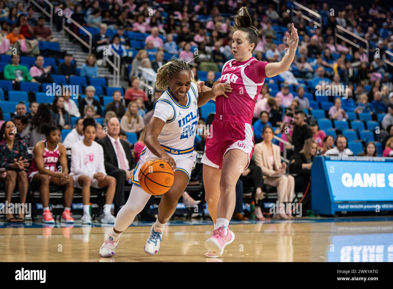 UCLA Bruins guard Charisma Osborne (20) drives against Utah Utes guard Kennady McQueen (24) during a NCAA women’s basketball game, Thursday, February Stock Photo