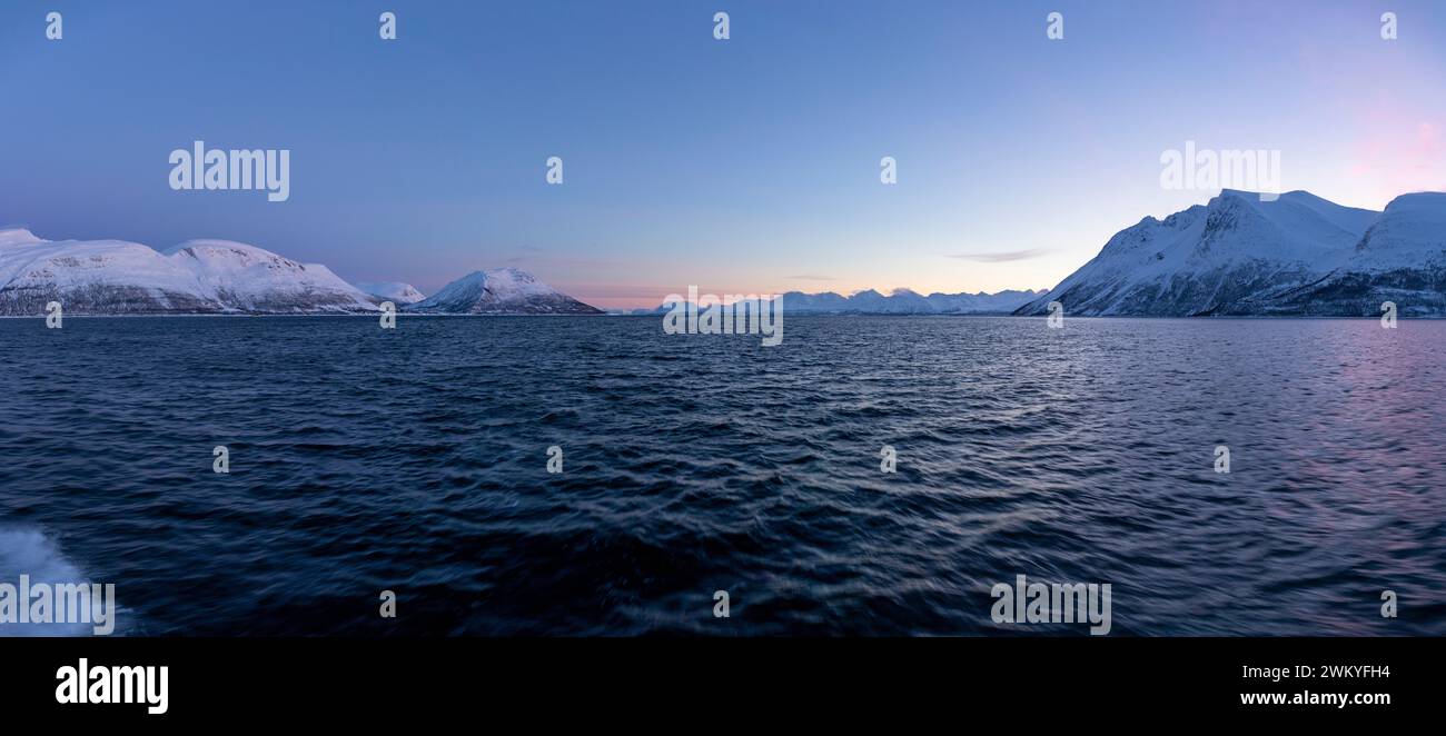 Europe, Norway, Tromso, Troms County, The Lyngen Alps across Ullsfjorden at Dawn from a boat near Tvillingan Stock Photo