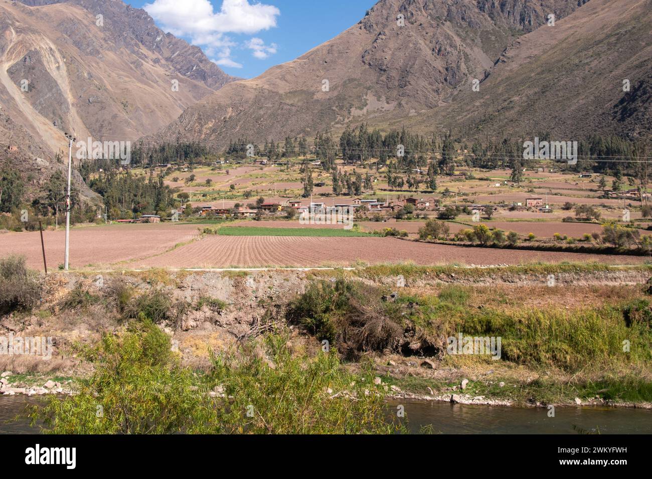 A view of the fields, river, mountains, and forests of the Sacred Valley along the Inca Trail in Peru Stock Photo