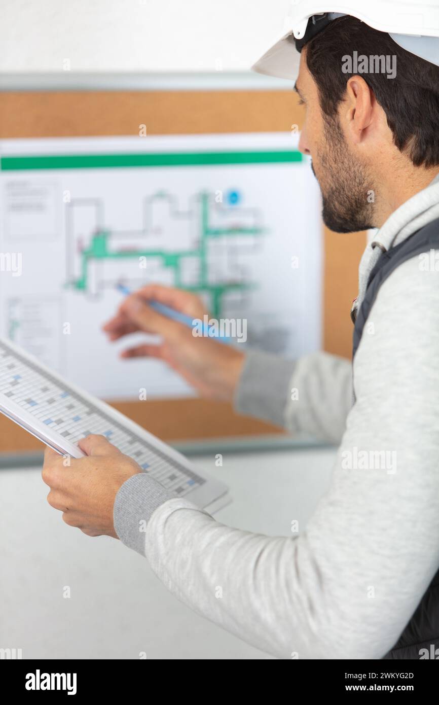 architect checking insulation during house construction Stock Photo
