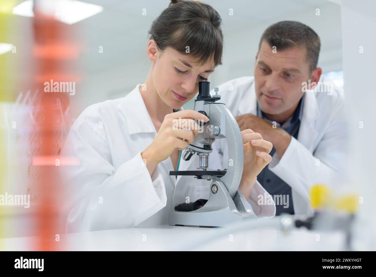 female scientist working in a lab with microscope Stock Photo - Alamy