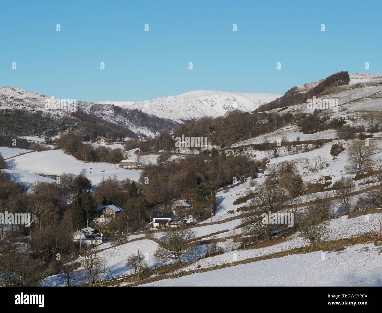 Snow covered houses and countryside in the Longsleddale valley from the A6 Kendal to Penrith road. Stock Photo