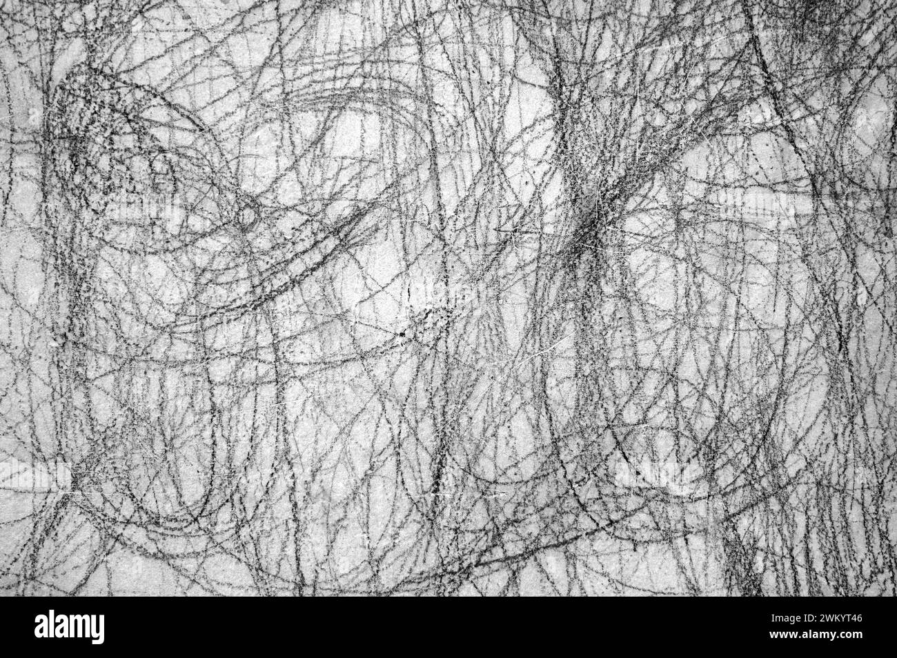 Abstract scribble, scrawl by pencil on the gray wall as texture or background Stock Photo