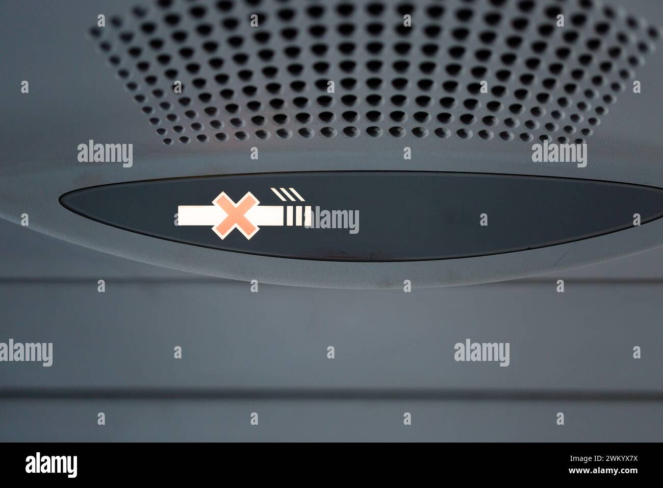 No smoke icon warning flashing  on plane. Full frame shot focus on the bright no-smoking pictogram Stock Photo