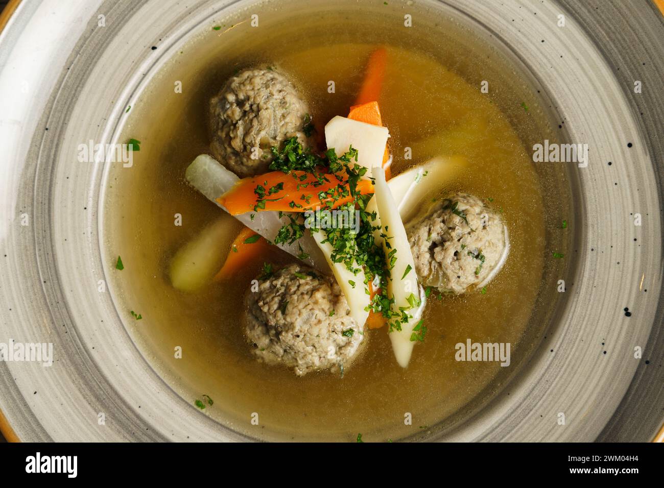 Goose soup, consommé with dumplings and vegetables Stock Photo
