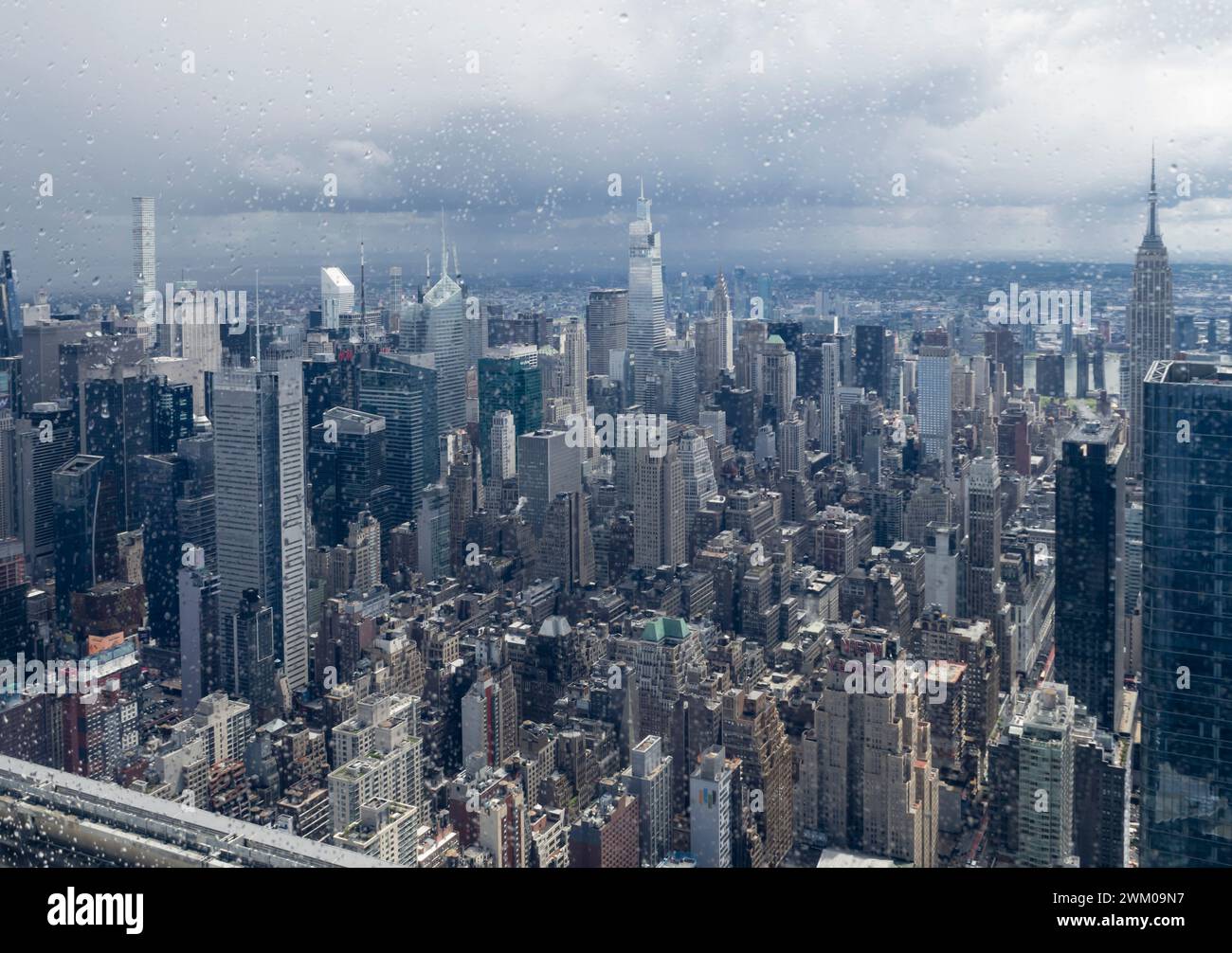 New York, USA - 2 May 2023: View of Midtown Manhattan, New York, with One Vanderbilt and Empire State Building with oncoming rain clouds. Looking thro Stock Photo