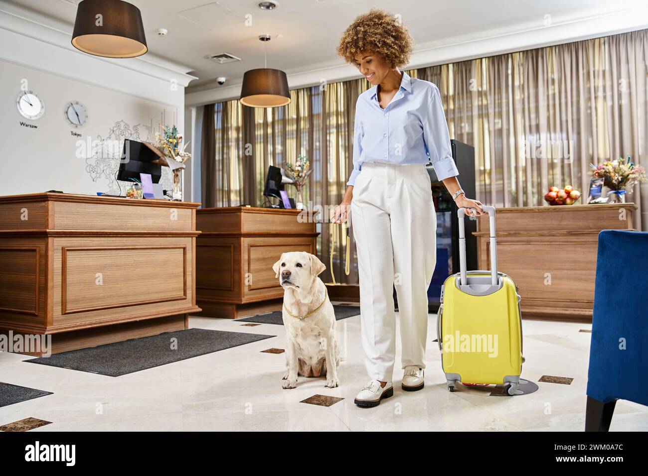 Image showcasing happy traveler with her Labrador in a pet-friendly hotel lobby, african ...