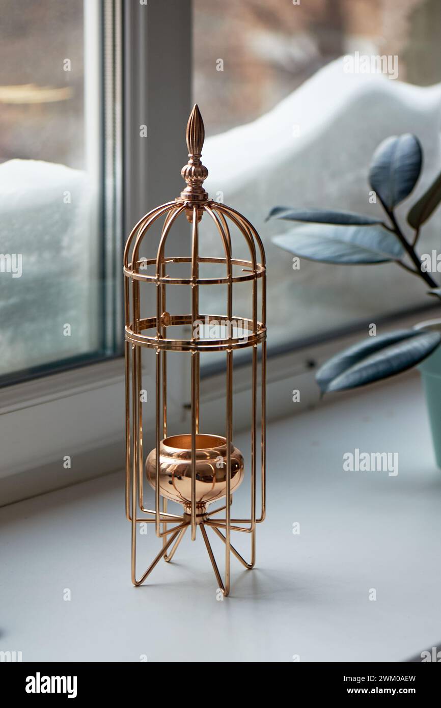 Gold metal candle holder in the shape of a bird cage. Interior detail Stock Photo