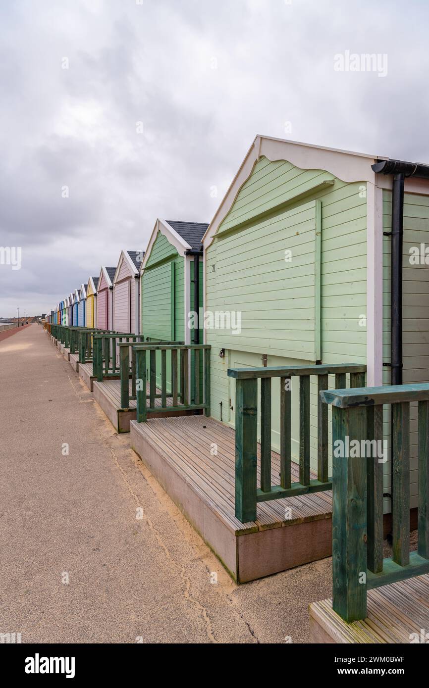 Vertical (Portrait orientation) Colourful beach huts shut for winter