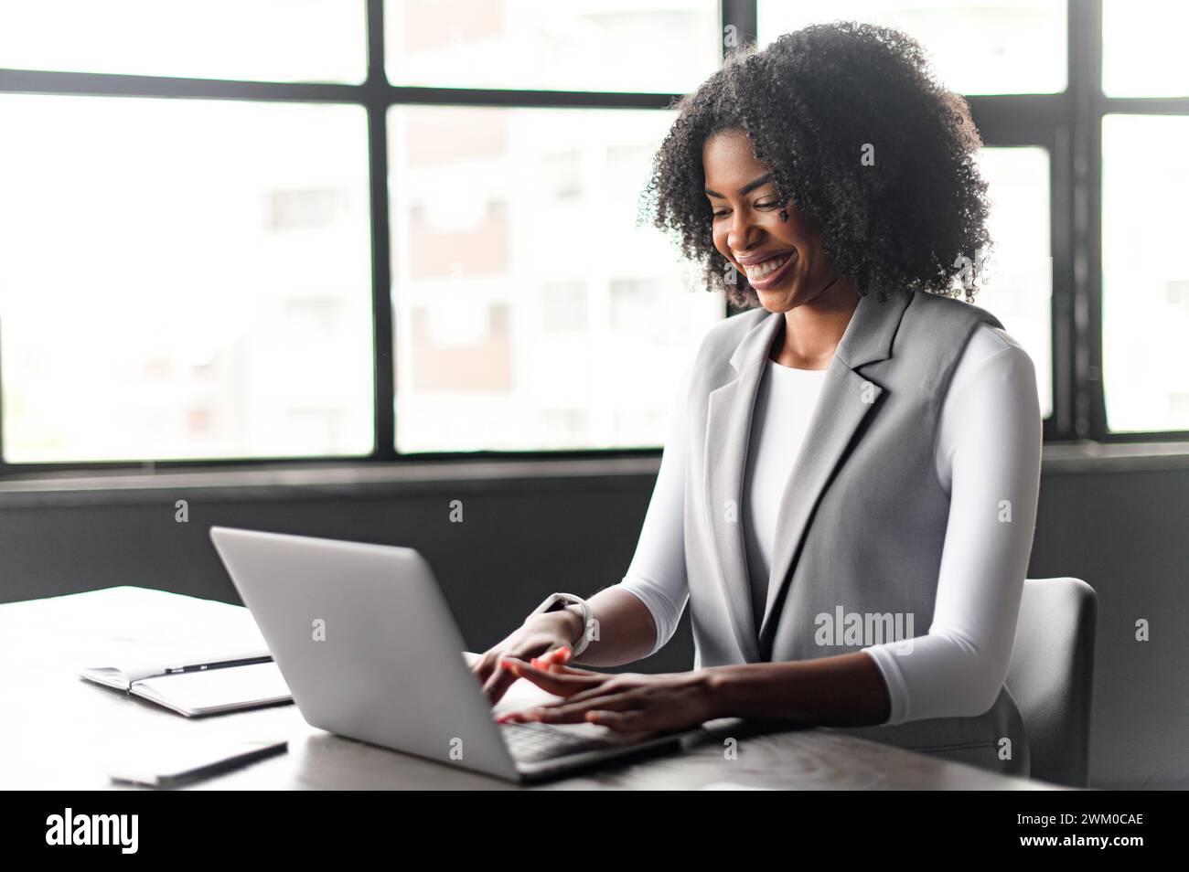 Captured in a moment of thought, the businesswoman looks ...