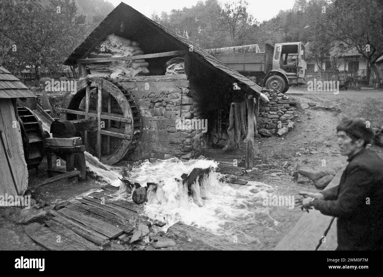 Vrancea County, Romania, 2000. Local water mill, with a wooden washing tub with whirlpool system for cleaning handmade wool blankets. Stock Photo