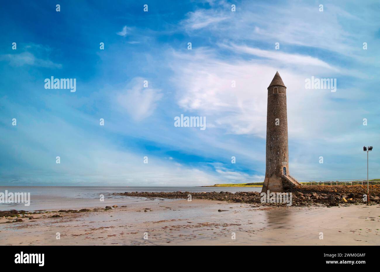 The Chaine memorial a mock, granite built, round tower at the entrance to Larne Lough in County Antrim, Northern Ireland built  in 1888. Stock Photo