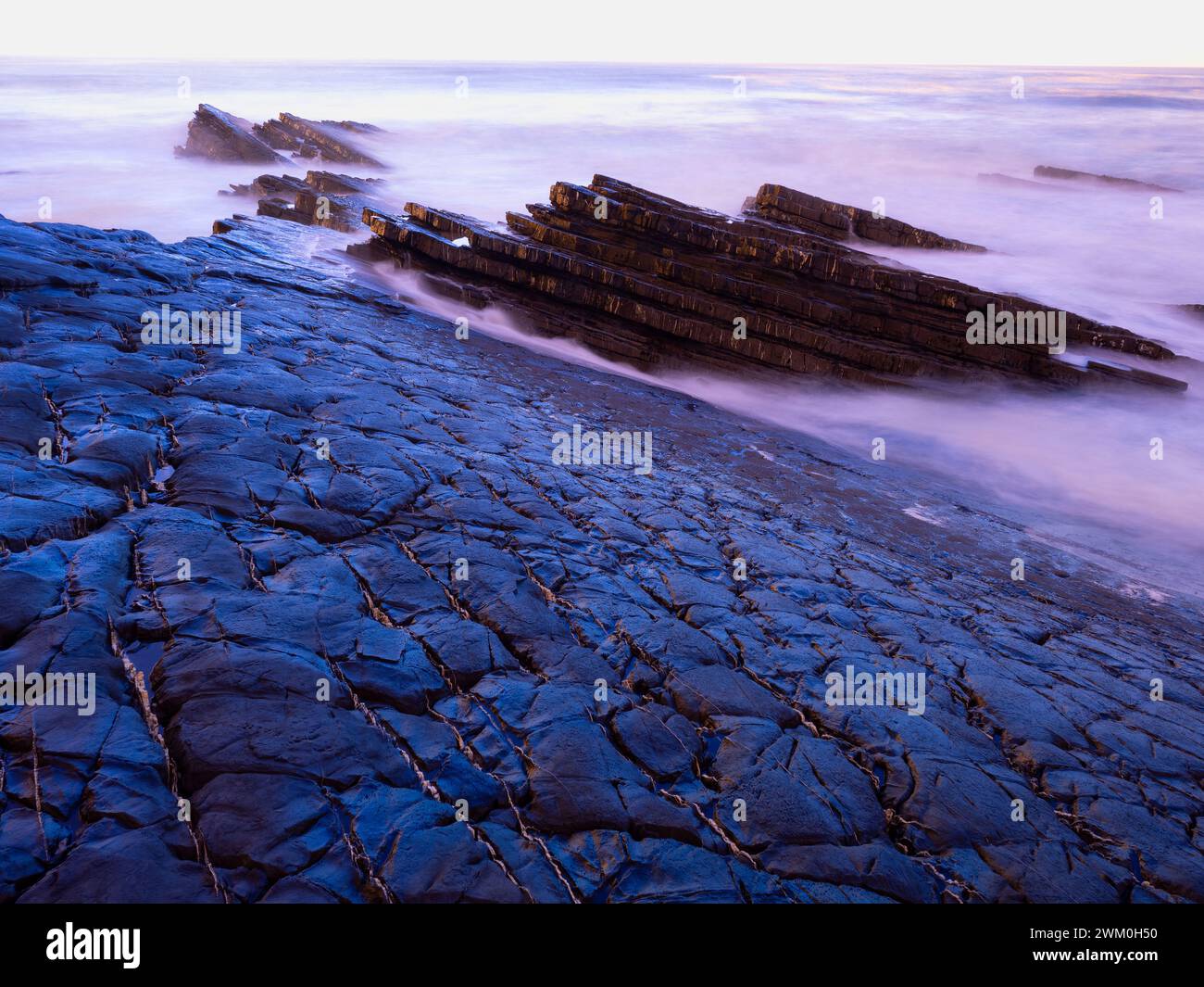 Portugal, Alentejo, Zambujeira do Mar, Long exposure of rocky beach at dusk Stock Photo