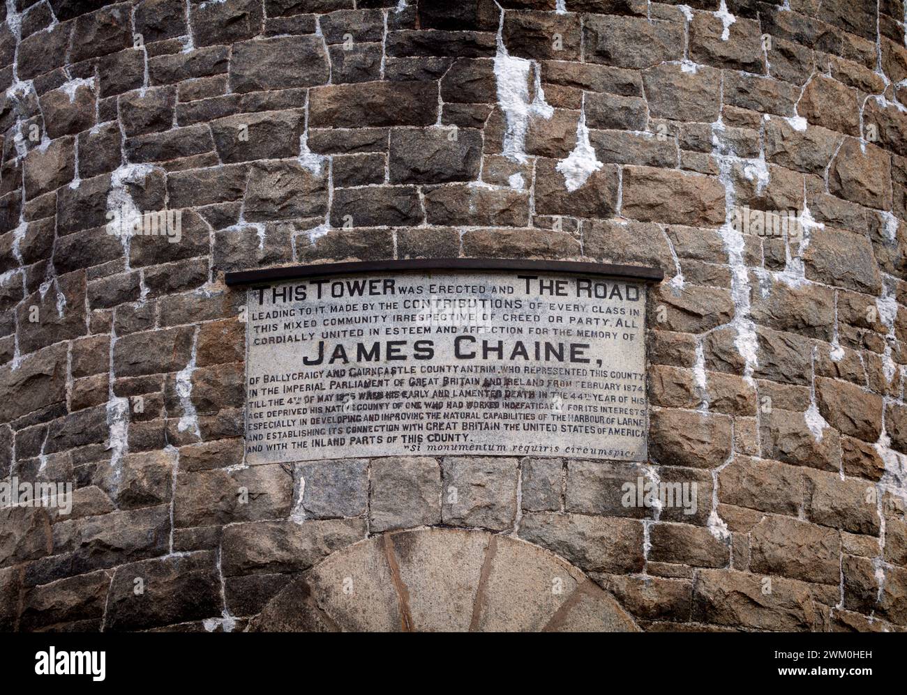 A dedication plaque on the Chaine memorial a mock round tower at the entrance to Larne Lough in County Antrim, Northern Ireland built  in 1888. Stock Photo
