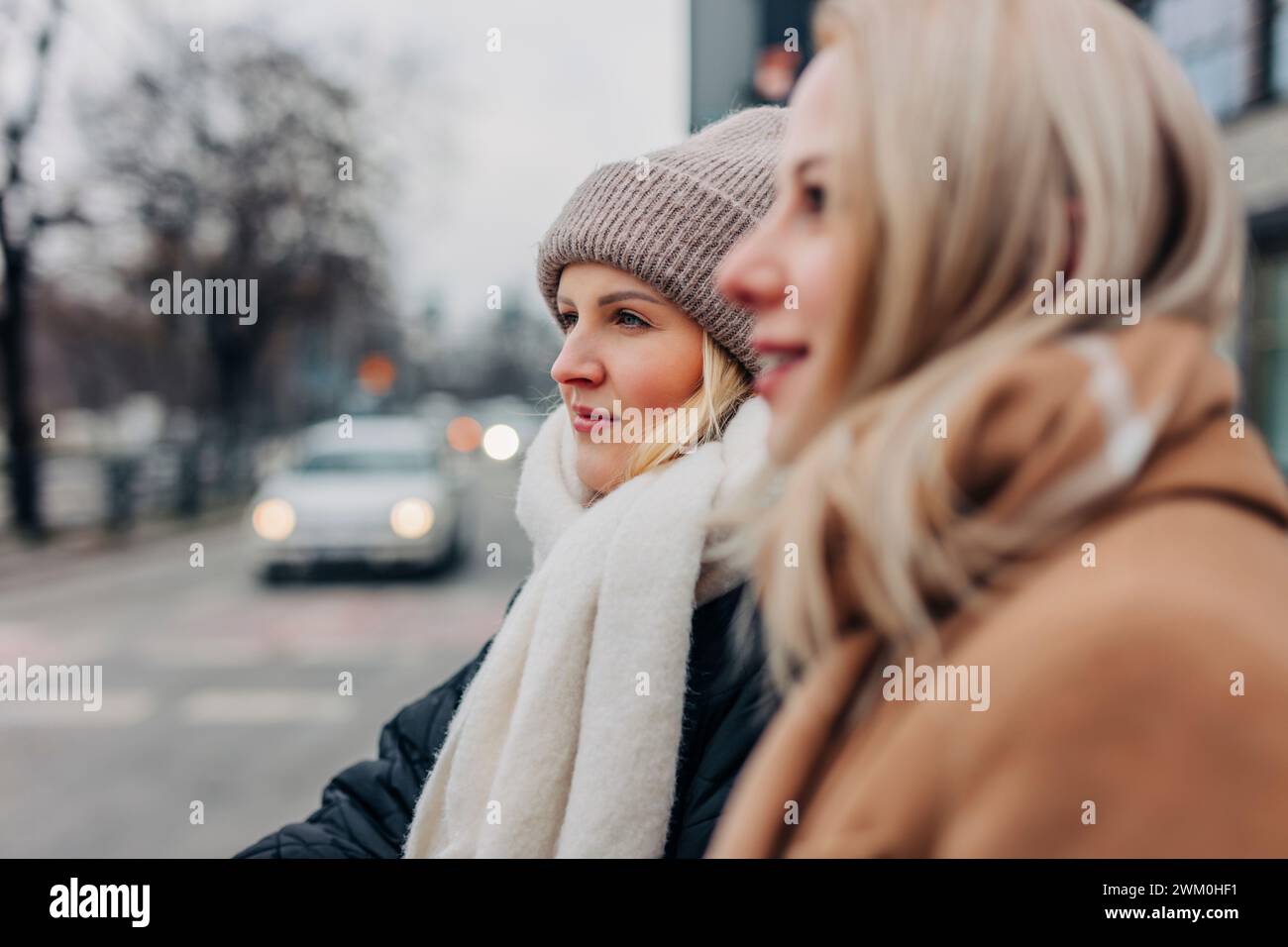 Friends wearing warm clothing at street Stock Photo