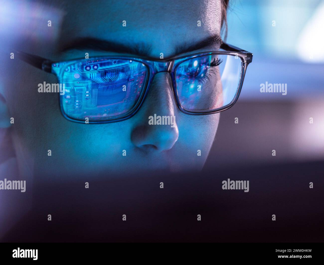 IT professional wearing eyeglasses and working on computer Stock Photo