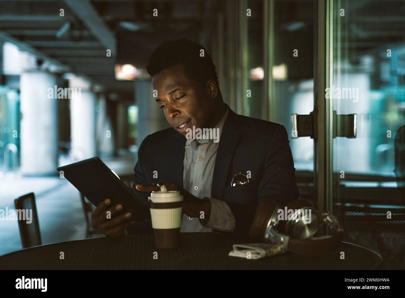 Businessman using tablet PC at cafe Stock Photo