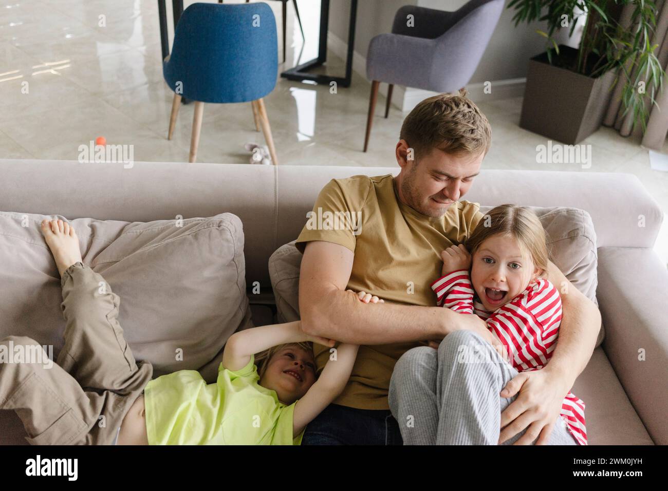 Father having fun with children at home Stock Photo