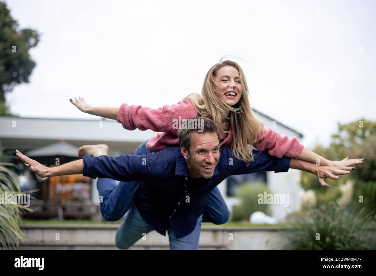 Couple playing piggyback ride in hi-res stock photography and images ...