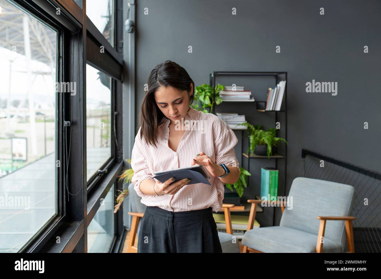 Businesswoman using tablet PC in office Stock Photo