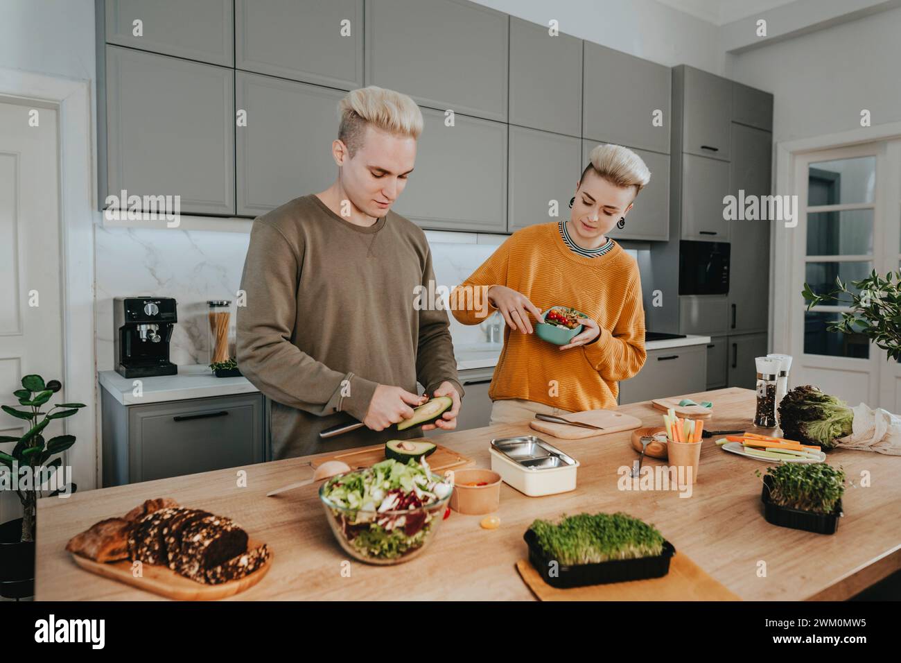 Young couple preparing healthy food for lunch boxes Stock Photo