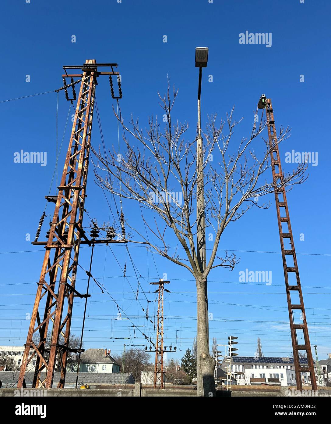 Electricity poles against blue sky Stock Photo - Alamy