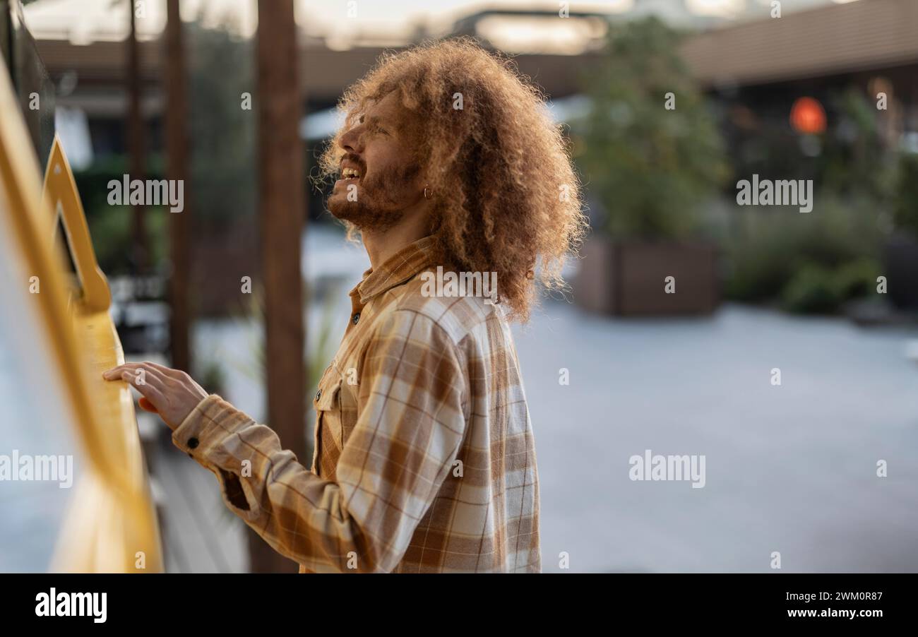 Smiling curly man standing hi-res stock photography and images - Alamy