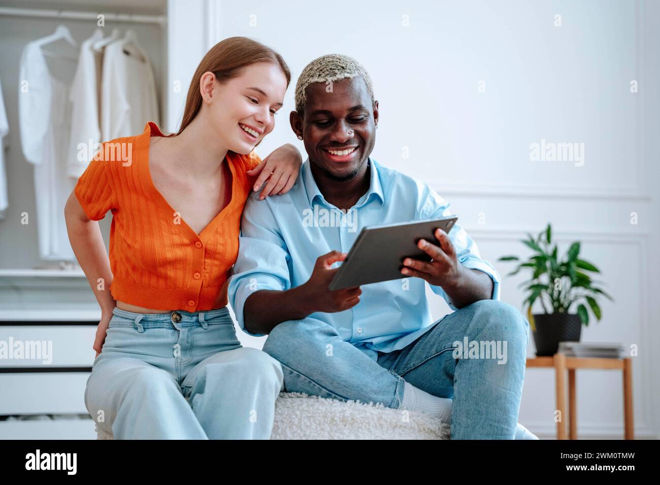 Happy young couple using tablet PC Stock Photo