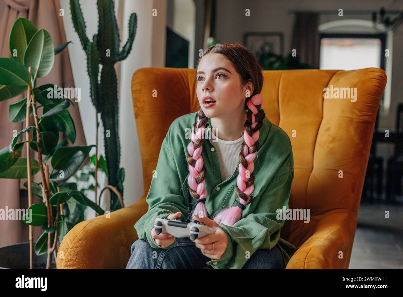 Young woman playing video game at home Stock Photo