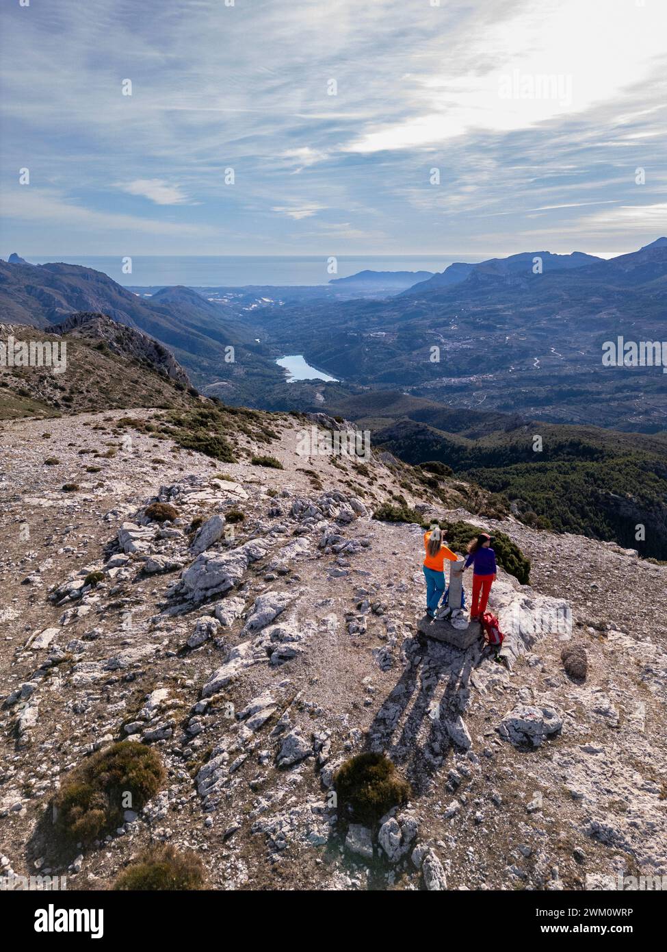 Two women hikers enjoying the beautiful nature from high above, Famorca, Alicante, Costa Blanca, Spain - stock photo Stock Photo