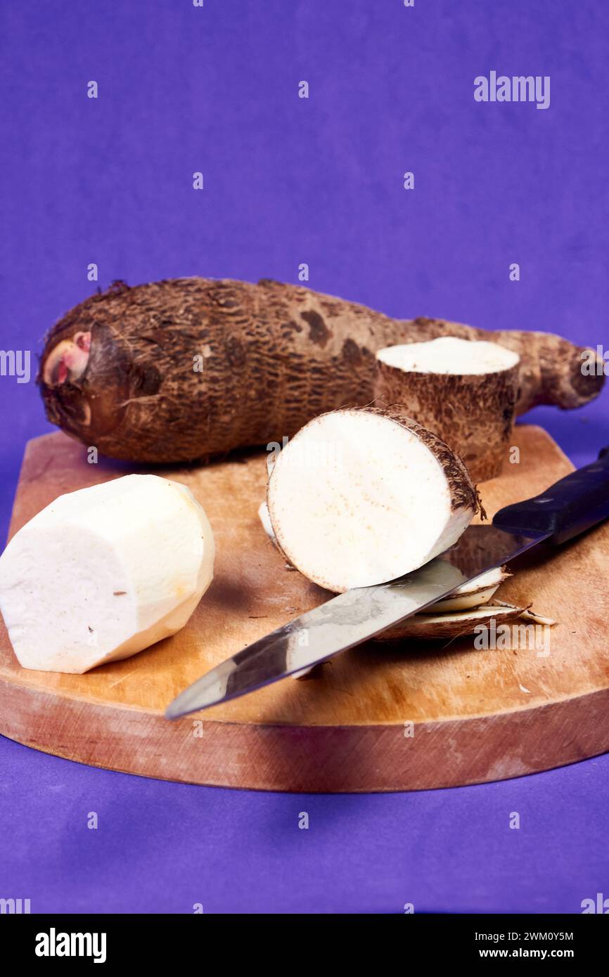 closeup of taro root vegetable, eddo malanga, purple background Stock ...