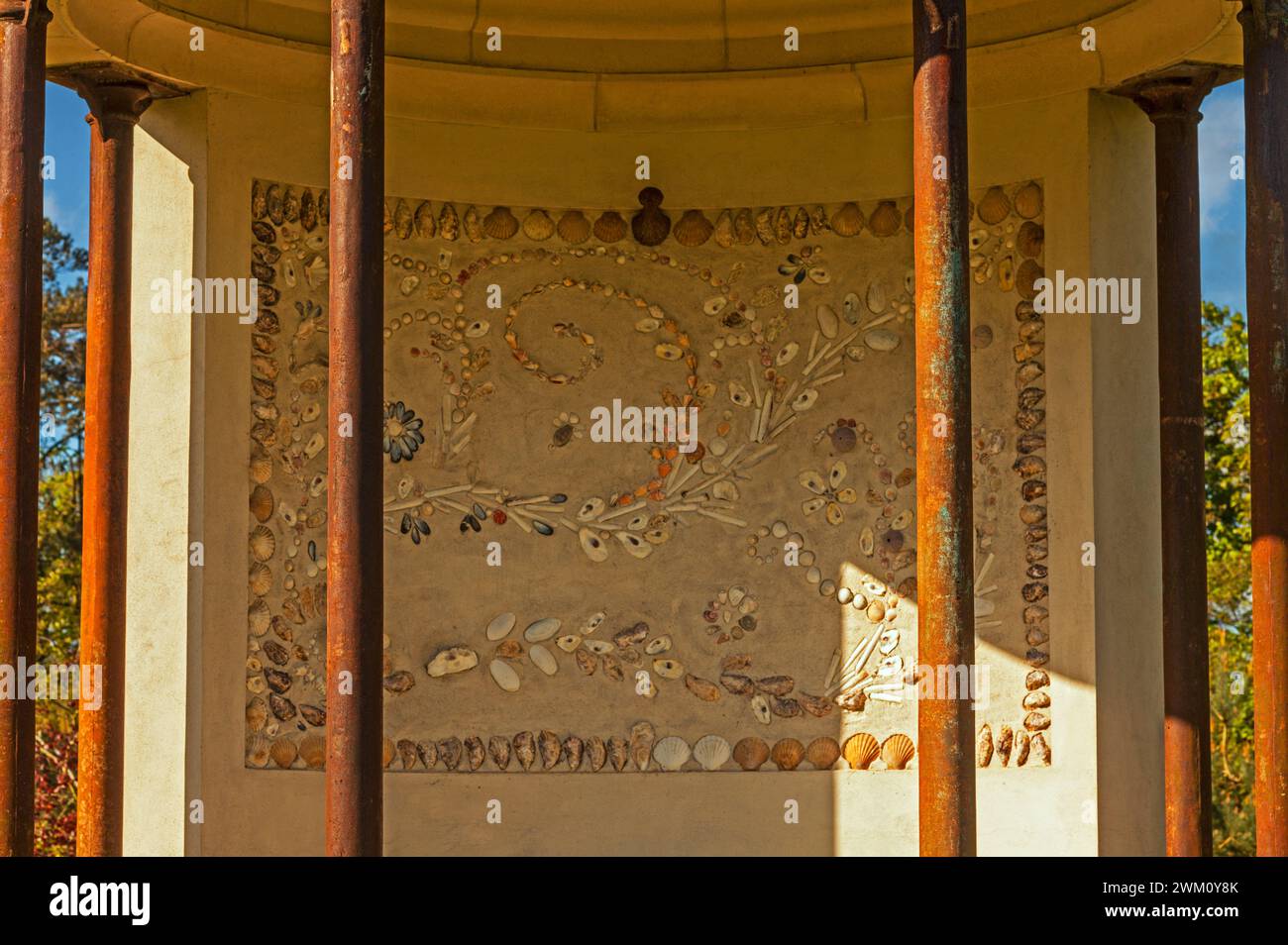 An elegant mural designed using seashells on the wall of the rare 21st-century folly in the shape of a garden temple in a private garden at Marlacoo i Stock Photo