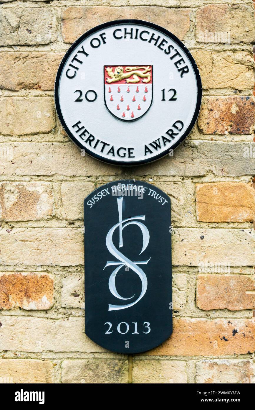 Plaques for City of Chichester Heritage Award 2012 and Sussex Heritage Trust 2013 on a building in Chichester, West Sussex. Stock Photo