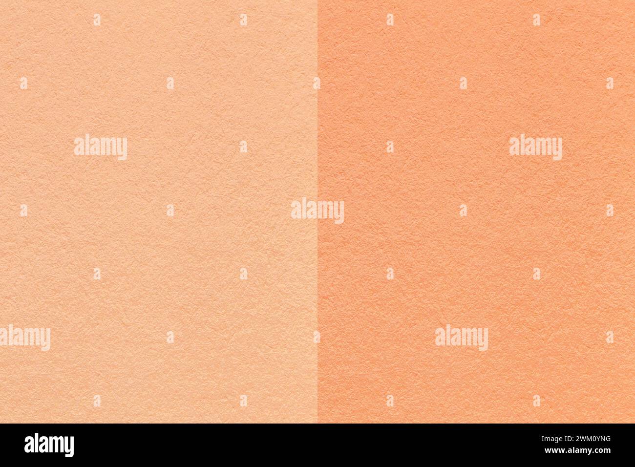 Color of the year 2024. Texture of craft peach fuzz and coral paper background, half two colors, macro. Structure of vintage dense cardboard. Felt bac Stock Photo