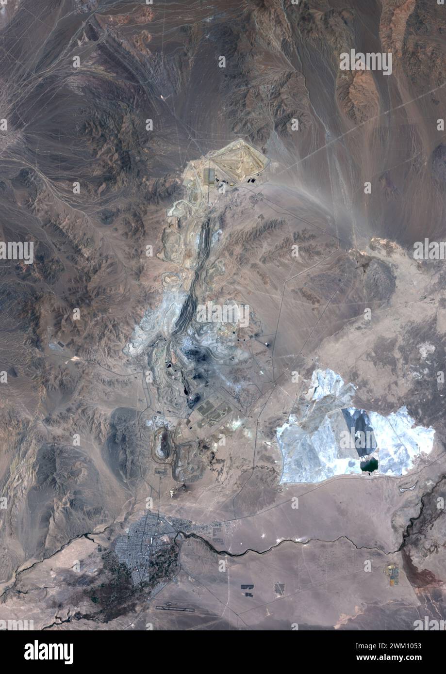 Color satellite image of Chuquicatama copper mine in Chile in 2023. Chuquicamata, also called Chuqui is the largest open pit copper mine in terms of excavated volume in the world. Stock Photo