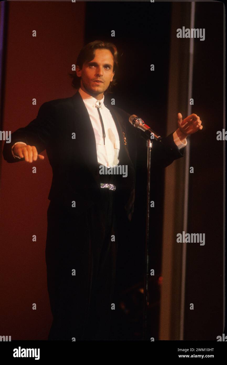3824333 Miguel Bose; (add.info.: Sanremo Music Festival 1988. Festival TV  presenter, Spanish pop singer Miguel Bosé, performing / Festival di Sanremo  1988. Il cantante Miguel Bosè, presentatore televisivo del Festival, canta  una, image size:865x1390