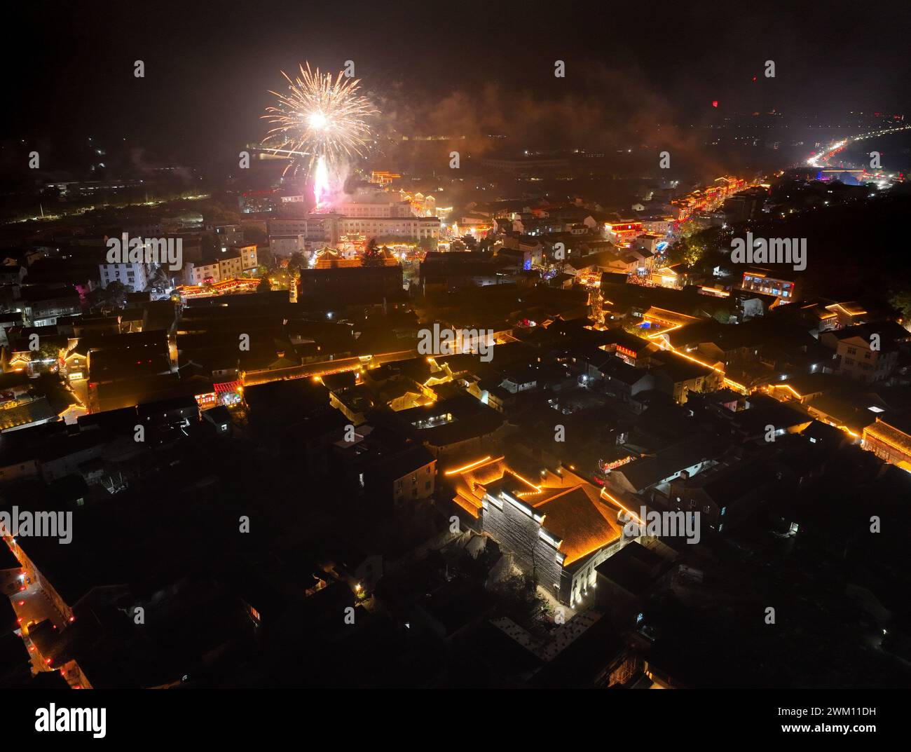 Ningbo, China's Zhejiang Province. 23rd Feb, 2024. An aerial drone photo shows fireworks exploding over Qiantong Town, Ninghai County, east China's Zhejiang Province, Feb. 23, 2024. With a history of over 500 years, the Qiantong Lantern Festival Parade was held here to memorize ancestors of the townsfolk. Credit: Weng Xinyang/Xinhua/Alamy Live News Stock Photo