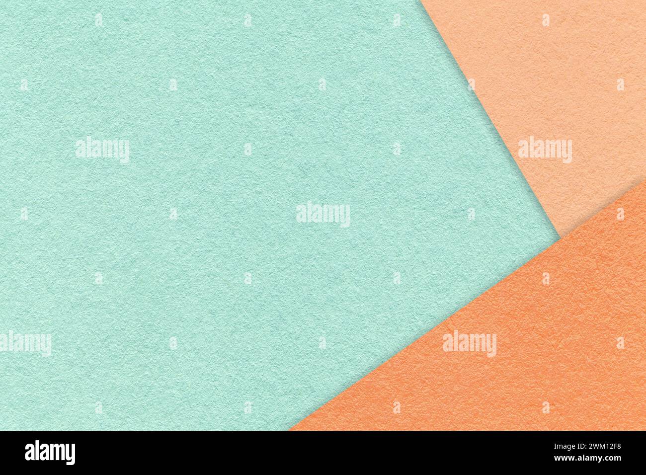 Texture of craft light cyan color paper background with peach fuzz and coral border. Vintage abstract mint cardboard. Presentation template and mockup Stock Photo