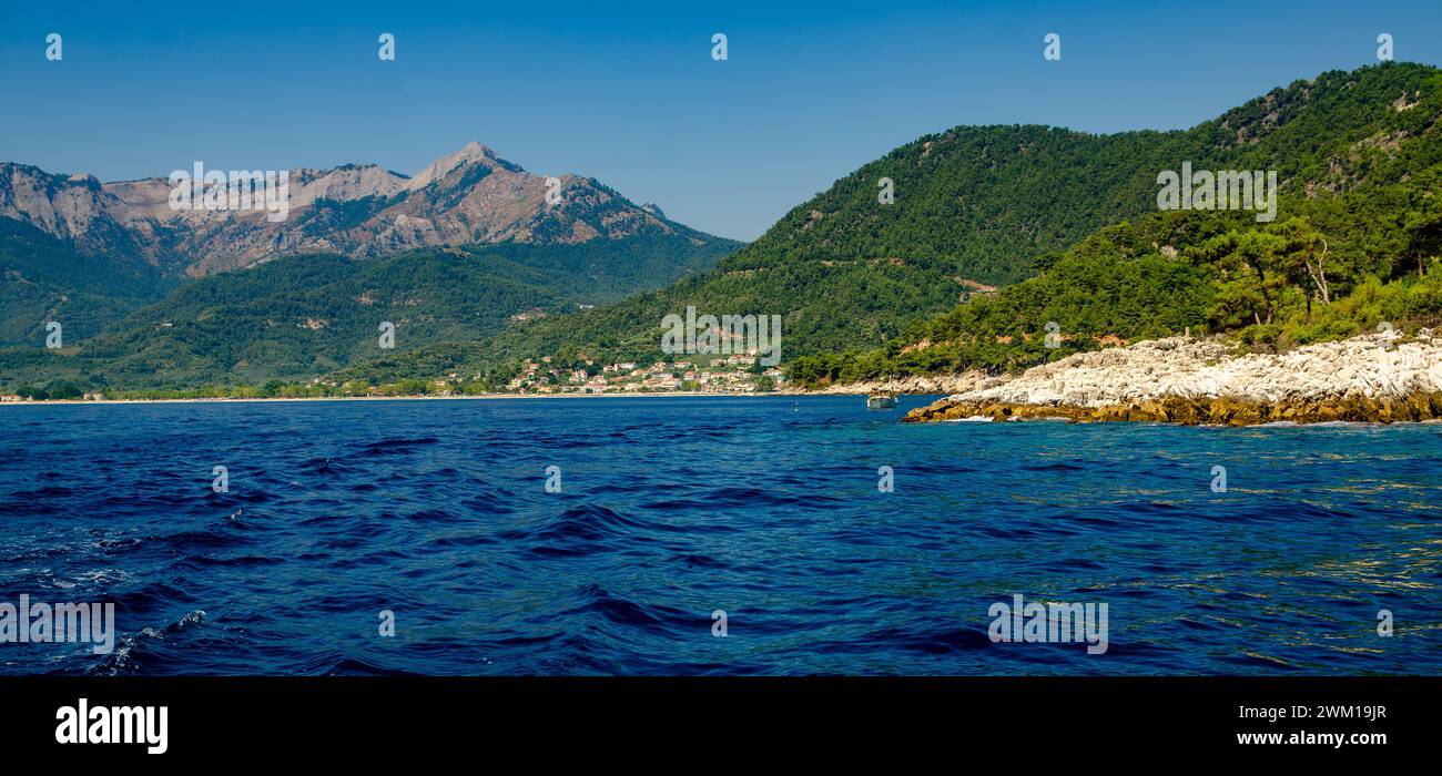 A picturesque lake with distant mountains in Thassos, Greece Stock Photo
