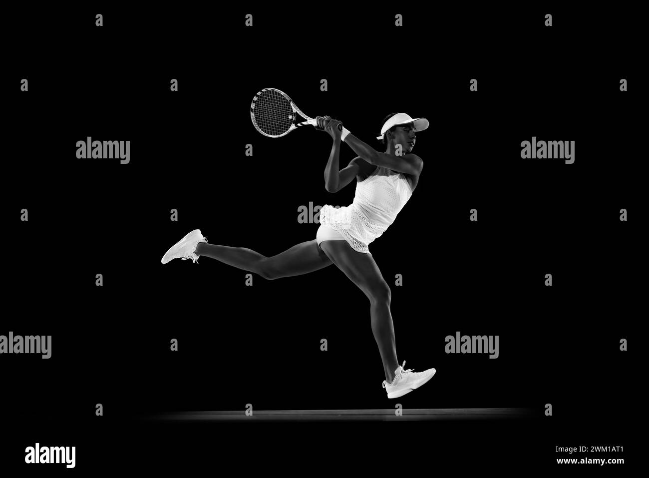 Focused athlete in tennis gear executing powerful forehand swing