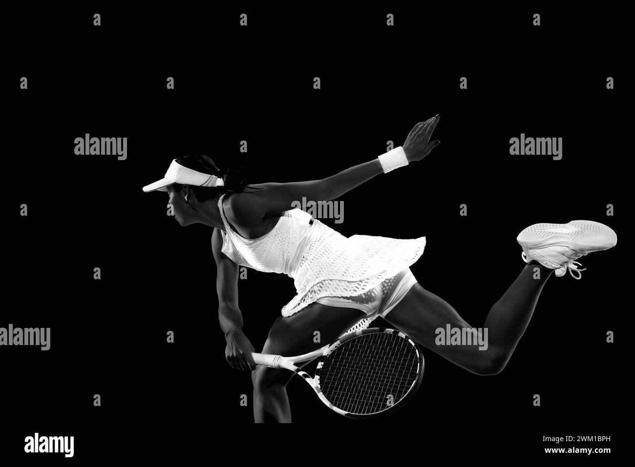 Action shot of female tennis player performing backhand stroke against ...