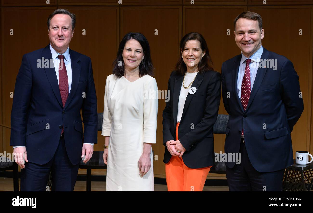 23 February 2024, USA, New York City: Annalena Baerbock (Alliance 90/The Greens, 2nd from left), Foreign Minister, stands with Radoslaw Sikorski (r), Foreign Minister of Poland, David Cameron (l), Foreign Secretary of the United Kingdom, and moderator Emma Tucker (2nd from right) before a panel discussion hosted by 'The Wall Street Journal' on support for Ukraine at New York University. Federal Foreign Minister Baerbock is in New York for the special sessions of the UN General Assembly and the UN Security Council to mark the second anniversary of the Russian invasion of Ukraine at the United N Stock Photo