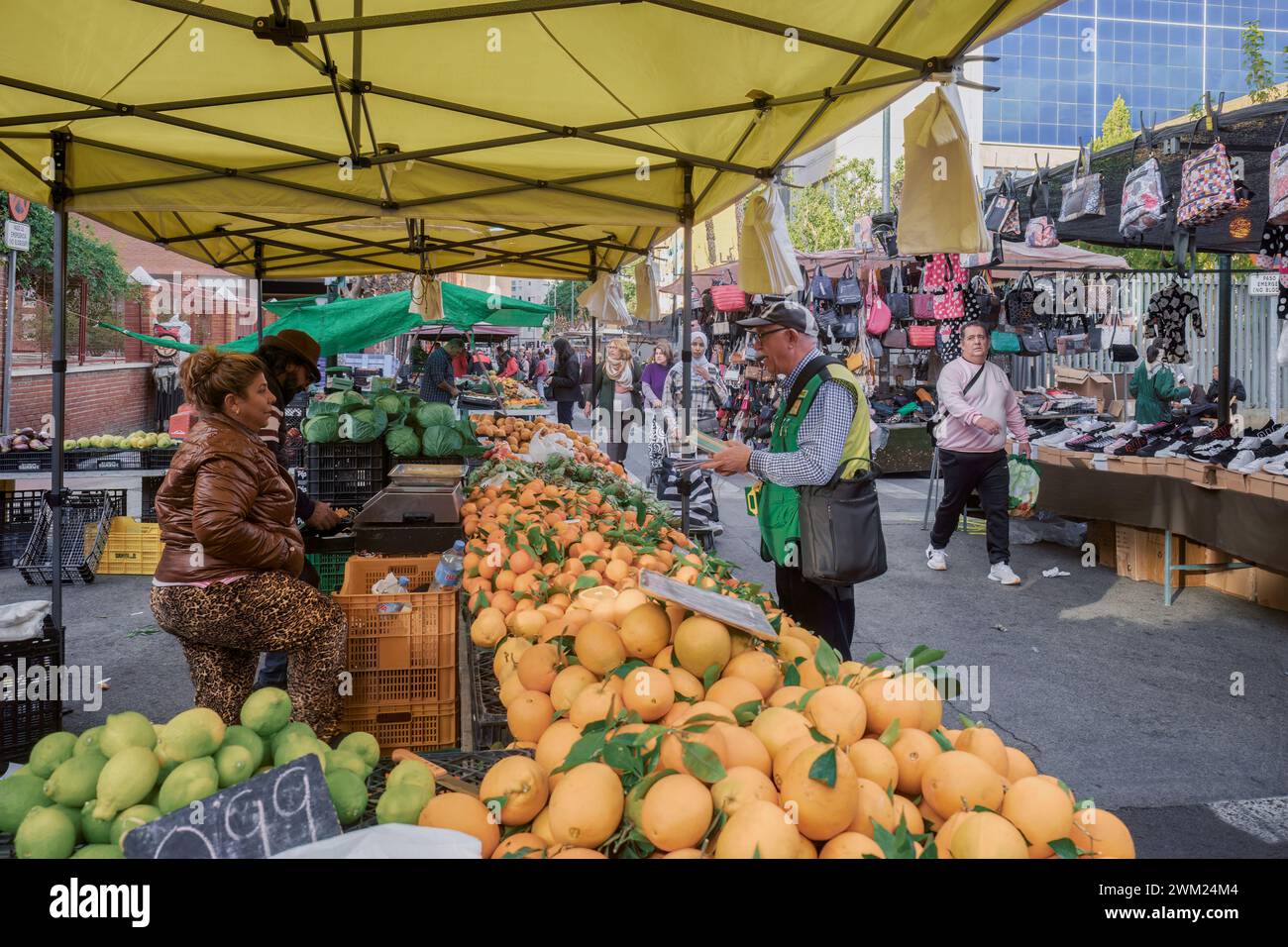 Street stalls with products, sellers and buyers at the weekly open-air Thursday market in the capital city of the Murcia region, Spain, Europe. Stock Photo