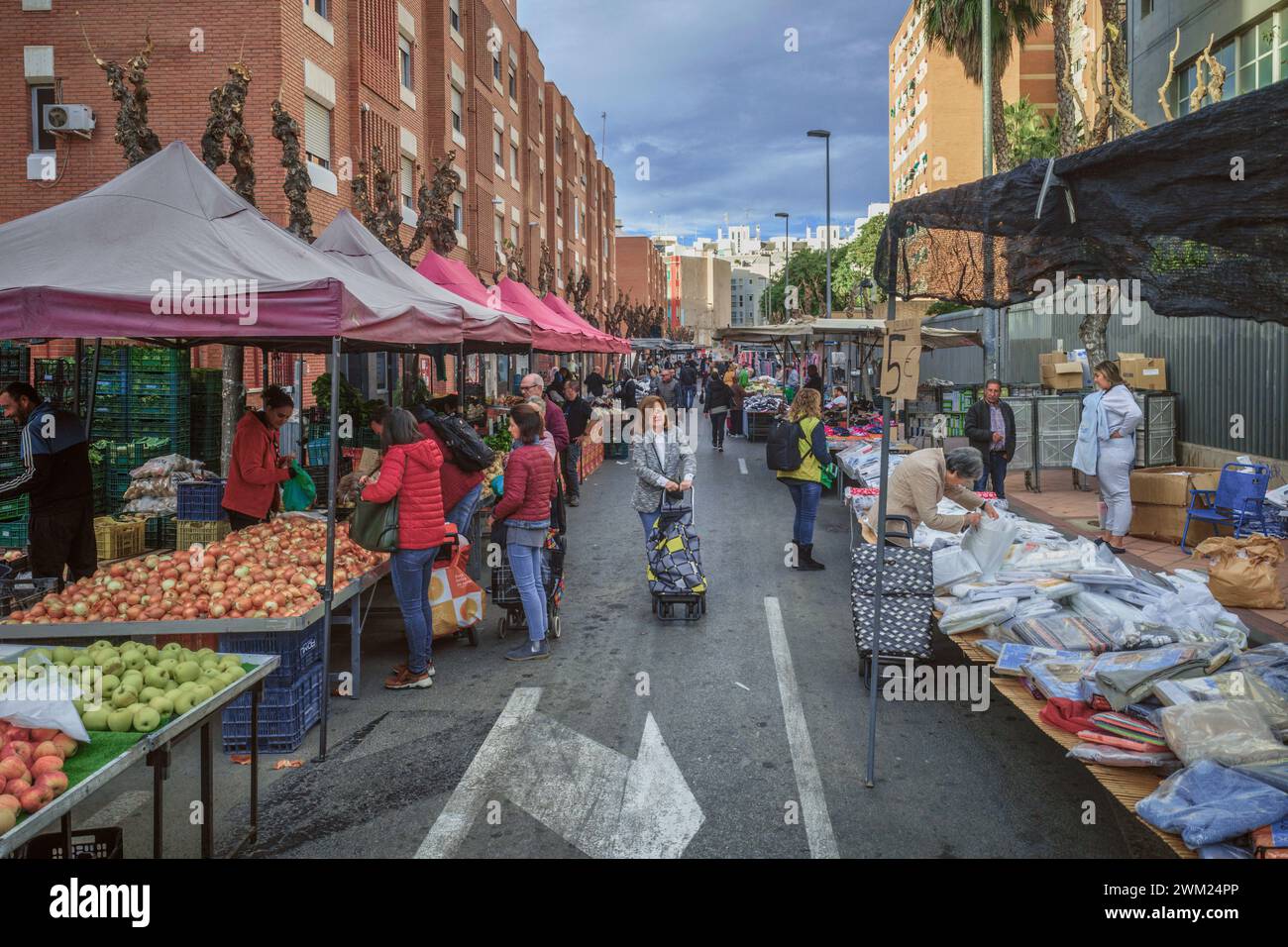 Street stalls with products, sellers and buyers at the weekly open-air Thursday market in the capital city of the Murcia region, Spain, Europe. Stock Photo