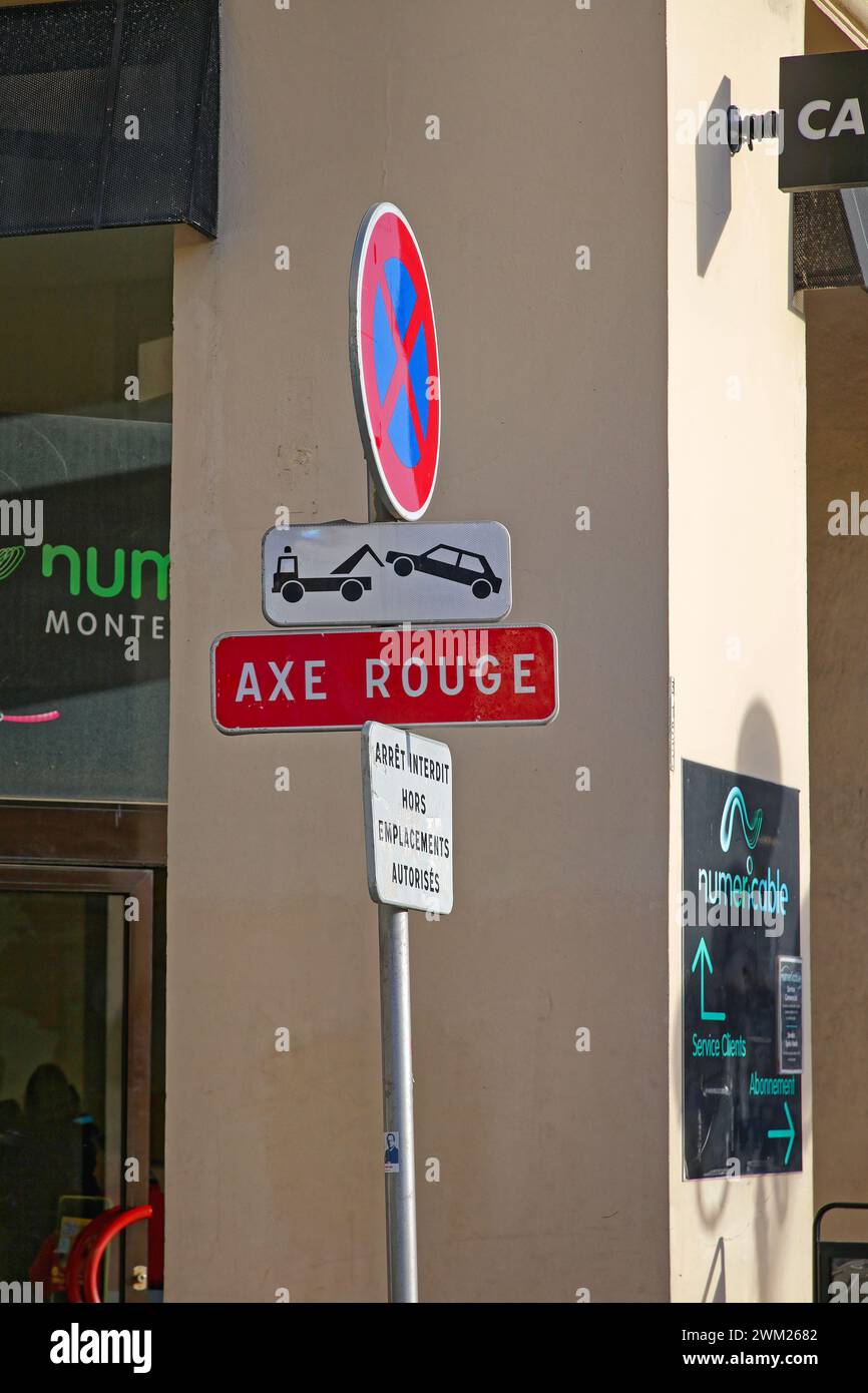 Nice, France - January 21, 2012: Red Axis No Parking Axe Rouge Traffic Sign at City Centre Street. Stock Photo