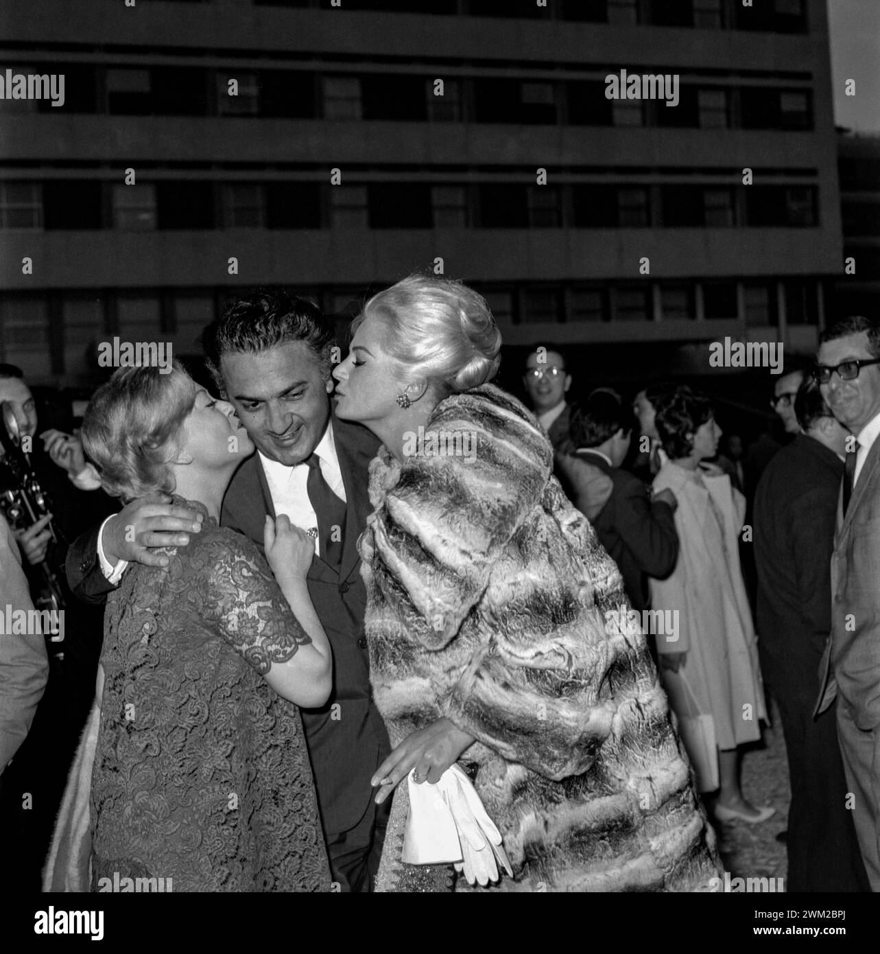 7395014 Party for the film 'Boccaccio '70'. Director Federico Fellini (centre) kissed by his wife Giulietta Masina (left) and Anita Ekberg, Rome, 1961 (b/w photo); Photo © Aldo Durazzi/Marcello Mencarini Archives. Stock Photo