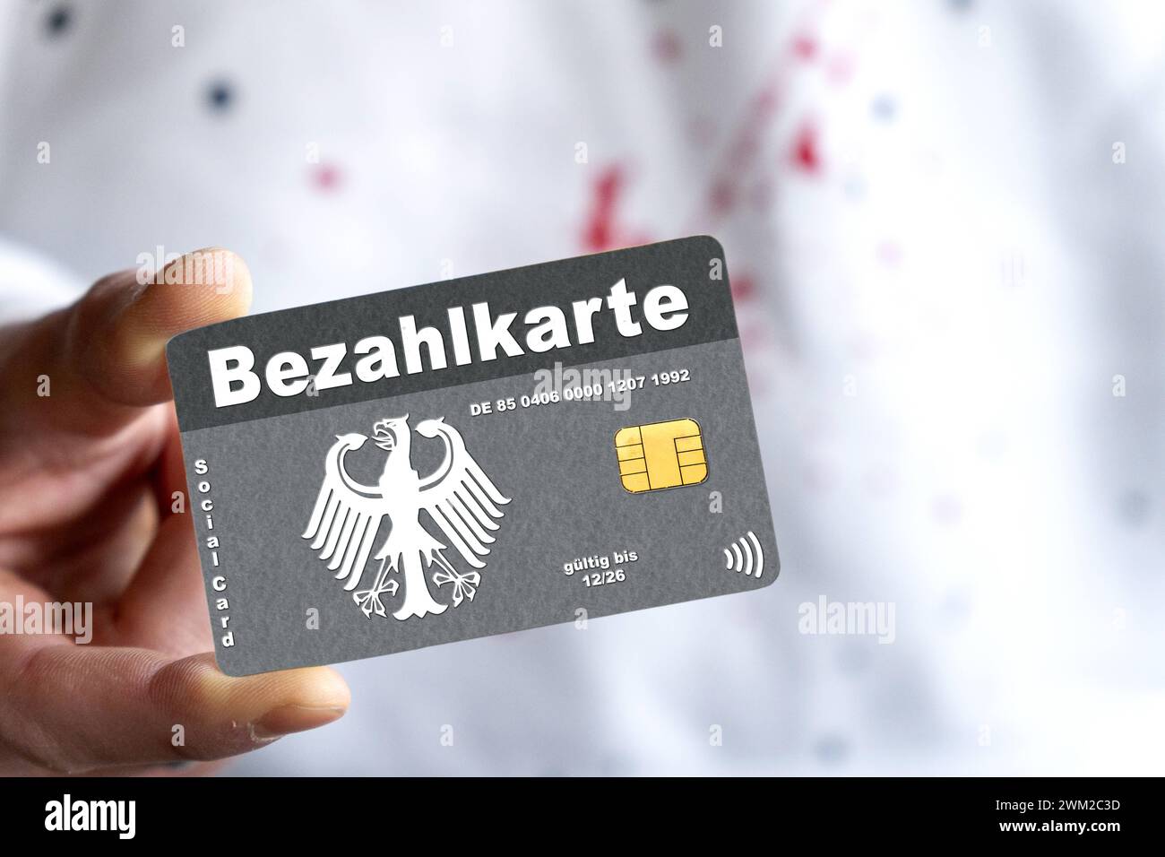 February 23, 2024: Payment card for refugees and migrants, A man holds a debit card with the inscription: Payment card, in his hand. PHOTOMONTAGE *** Bezahlkarte für Flüchtlinge und Migranten, Ein Mann hält eine EC-Karte mit der Aufschrift: Bezahlkarte, in der Hand. FOTOMONTAGE Stock Photo